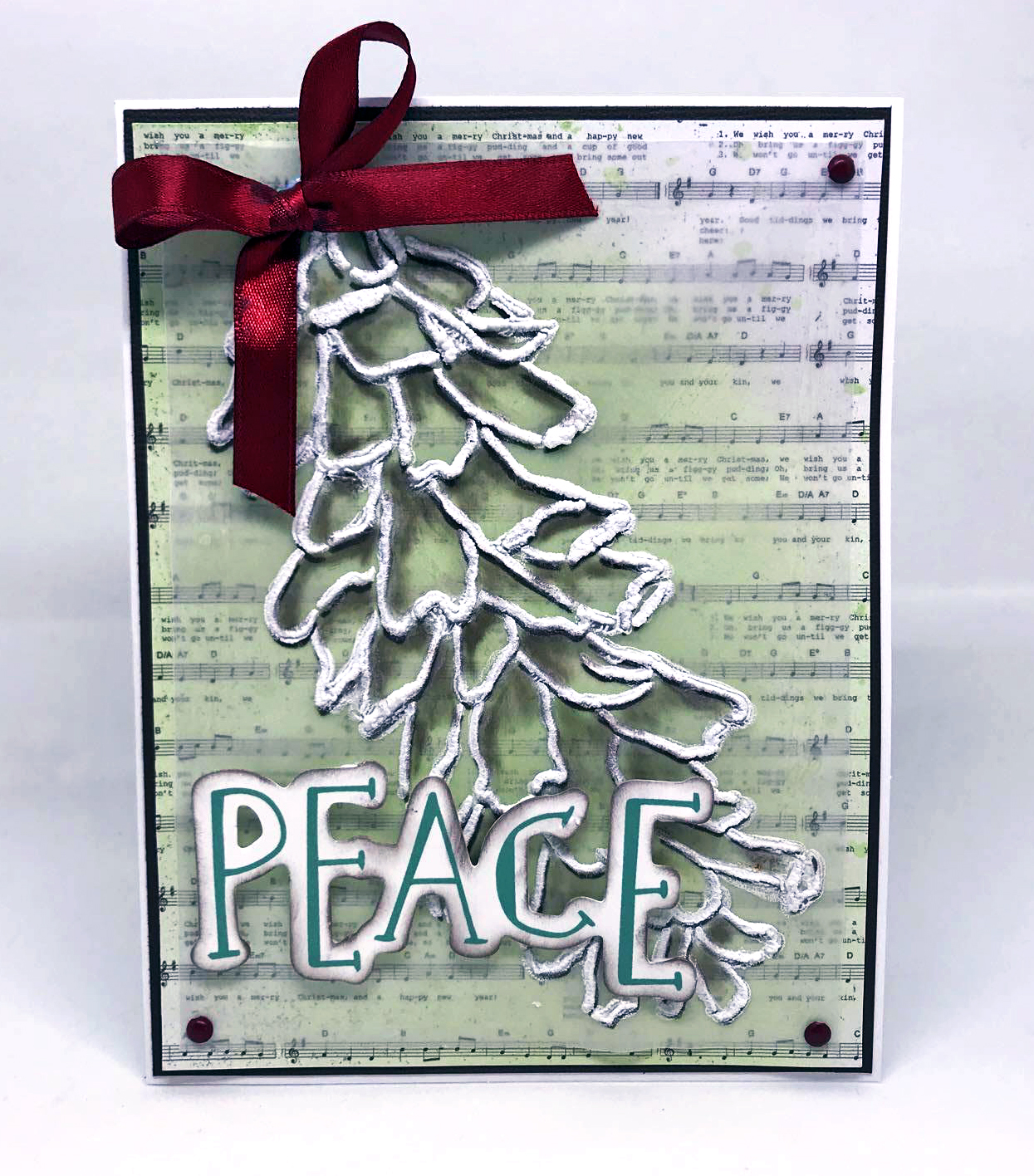 Christmas card featuring a flocked Pinecone created using Radiant Neon Amplify. Using a paper card base and a vellum overlay, Nadine Carlier's Christmas card is a fun yet elegant design.